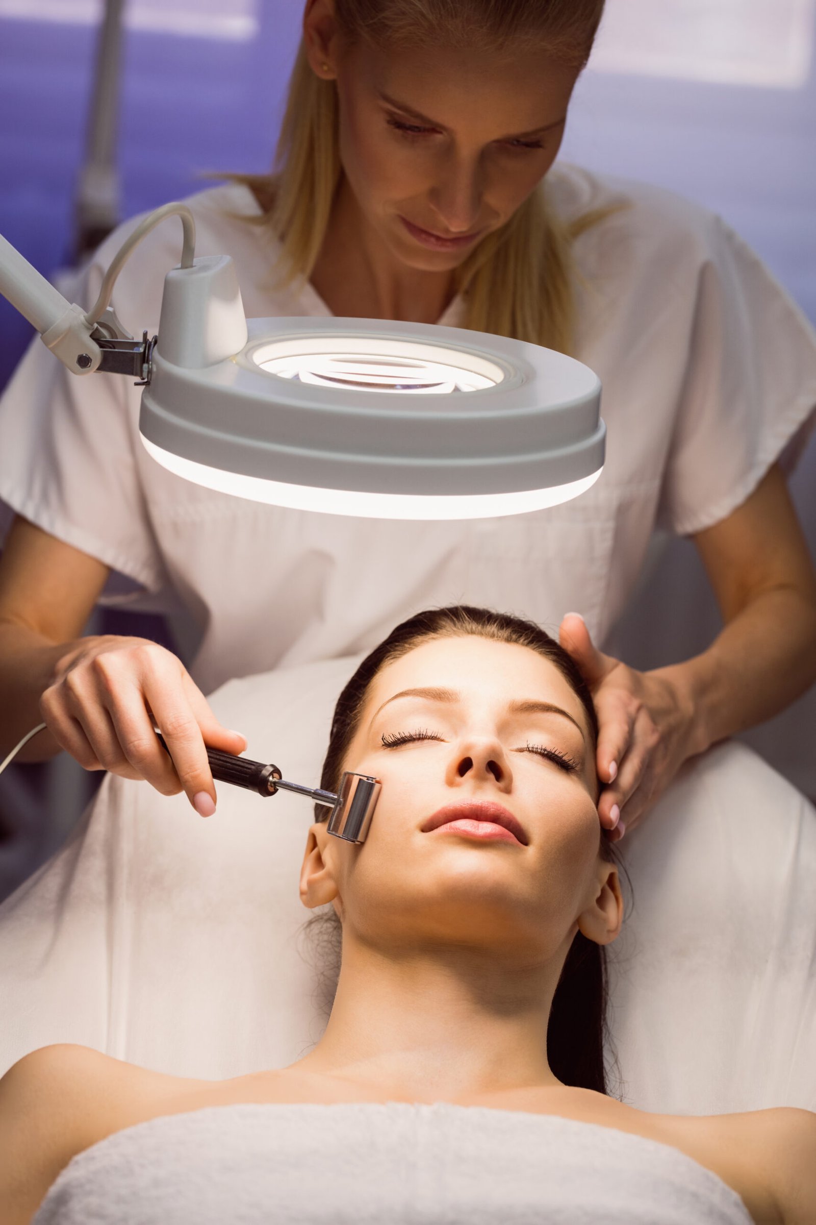 dermatologist performing laser hair removal patient scaled