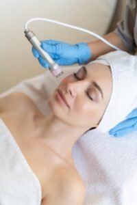 young woman lying cosmetologist s table rejuvenation procedure cosmetologist take care about neck face skin youthfull wellness hardware face cleaning procedure